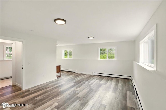309 Stewart St, Anchorage, AK 99508 - empty room featuring a baseboard radiator, baseboard heating, and wood finished floors