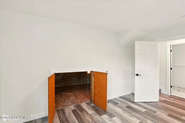 309 Stewart St, Anchorage, AK 99508 - unfurnished bedroom with wood finished floors and baseboards
