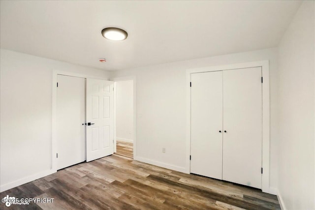 309 Stewart St, Anchorage, AK 99508 - unfurnished bedroom featuring wood finished floors and a closet