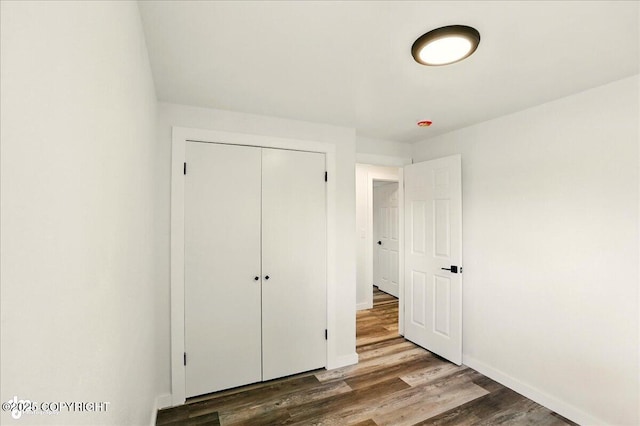309 Stewart St, Anchorage, AK 99508 - unfurnished bedroom featuring wood finished floors and a closet