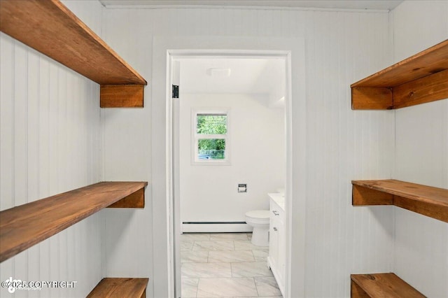 309 Stewart St, Anchorage, AK 99508 - bathroom with a baseboard radiator, marble look tile flooring, vanity, and wood walls