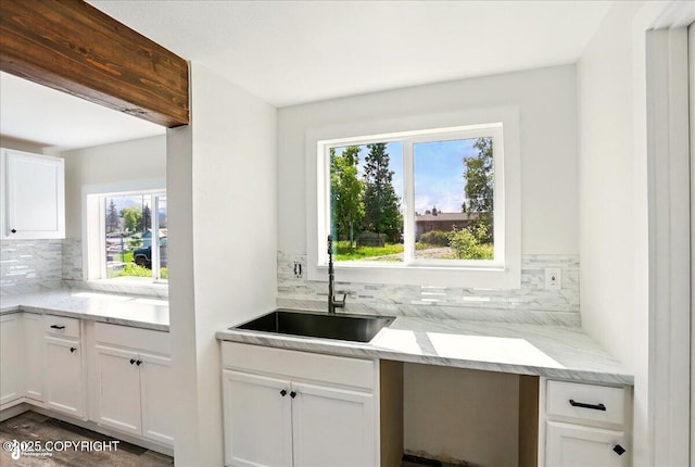 309 Stewart St, Anchorage, AK 99508 - kitchen featuring tasteful backsplash, healthy amount of natural light, and white cabinetry