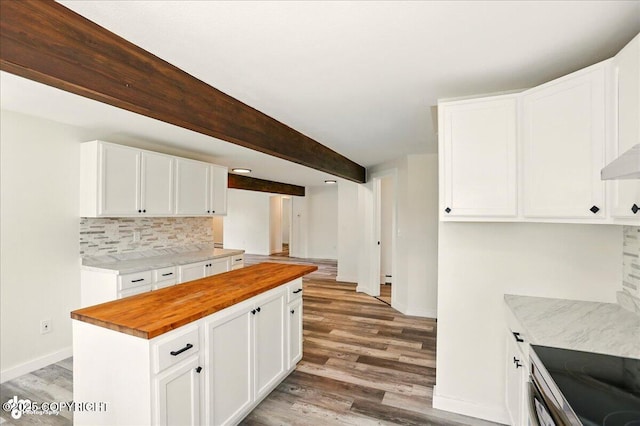 309 Stewart St, Anchorage, AK 99508 - kitchen featuring butcher block countertops, light wood-style flooring, decorative backsplash, and white cabinetry