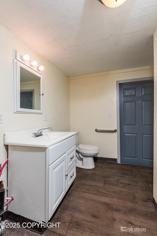 3521 N Caribou St, Wasilla, AK 99654 - bathroom featuring vanity, wood finished floors, and a textured ceiling
