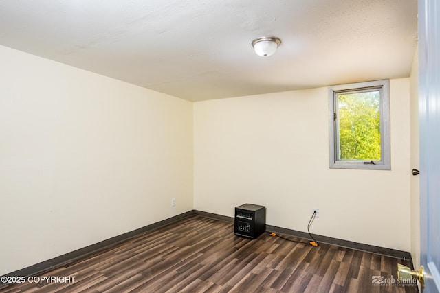 3521 N Caribou St, Wasilla, AK 99654 - spare room featuring dark wood-type flooring and baseboards
