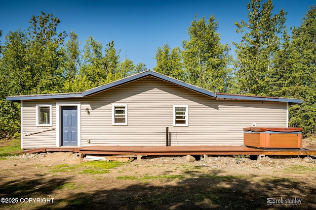 3521 N Caribou St, Wasilla, AK 99654 - back of property with a wooden deck and a hot tub