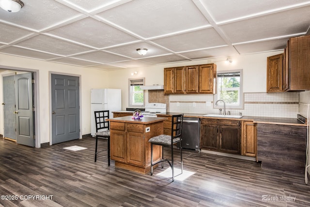 3521 N Caribou St, Wasilla, AK 99654 - kitchen featuring white appliances, coffered ceiling, plenty of natural light, tasteful backsplash, and dark wood finished floors