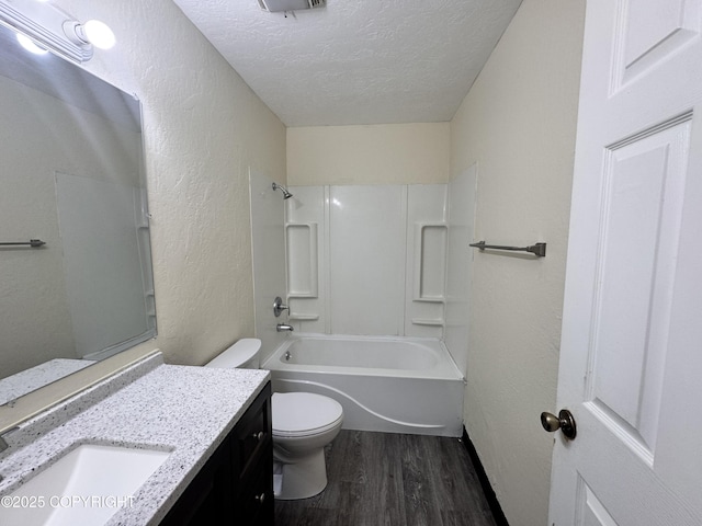 544 N Park St, Anchorage, AK 99508 - bathroom with a textured ceiling, wood finished floors, a textured wall, vanity, and tub / shower combination