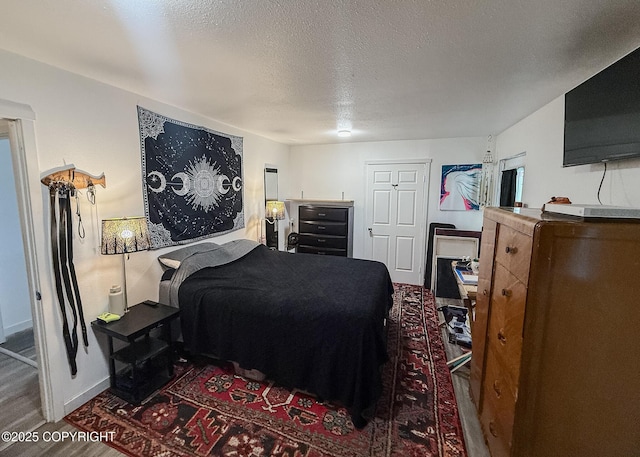 1245 N Miller Cir, Houston, AK 99623 - bedroom featuring a textured ceiling and wood finished floors