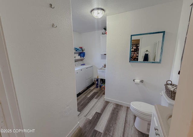 1245 N Miller Cir, Houston, AK 99623 - bathroom with washer and clothes dryer, wood finished floors, vanity, and a textured ceiling