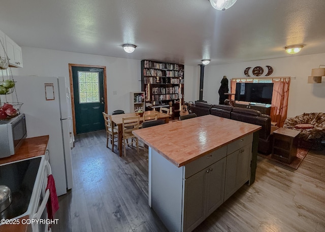 1245 N Miller Cir, Houston, AK 99623 - kitchen with wood counters, white electric stove, wood finished floors, a center island, and gray cabinets