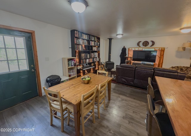 1245 N Miller Cir, Houston, AK 99623 - dining space featuring a wood stove and dark wood-style flooring