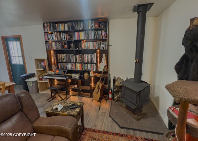 1245 N Miller Cir, Houston, AK 99623 - sitting room with a wood stove and wood finished floors
