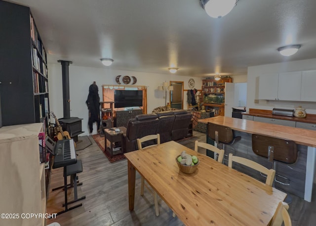 1245 N Miller Cir, Houston, AK 99623 - dining area featuring a wood stove and wood finished floors