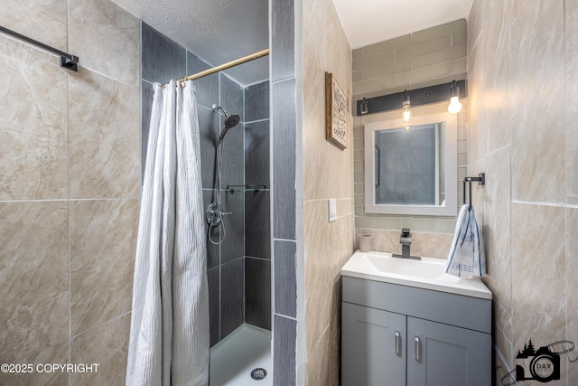 3501 N Calder Rd, Wasilla, AK 99654 - bathroom with tile walls, a shower stall, and vanity