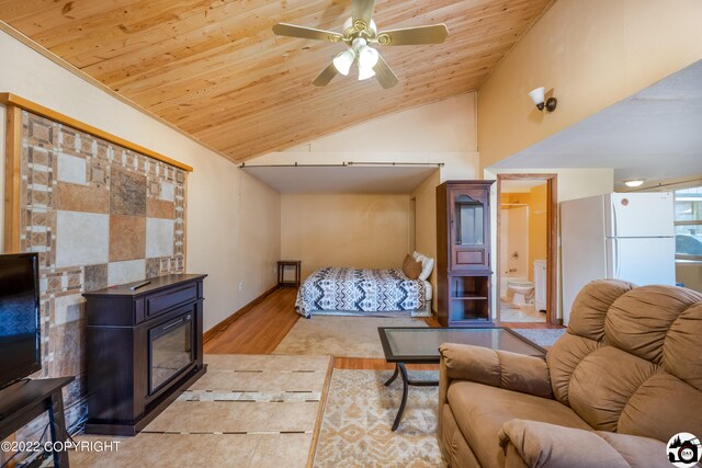 12230 Nautical Ave, Seward, AK 99664 - bedroom with freestanding refrigerator, lofted ceiling, wooden ceiling, wood finished floors, and ensuite bath