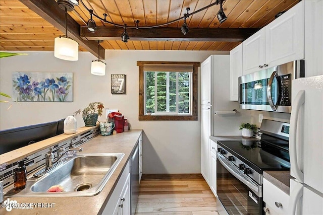 5968 Kenai Spur Highway, Kenai, AK 99611 - kitchen with appliances with stainless steel finishes, a wooden ceiling with exposed beams, light wood-type flooring, white cabinetry, and hanging light fixtures