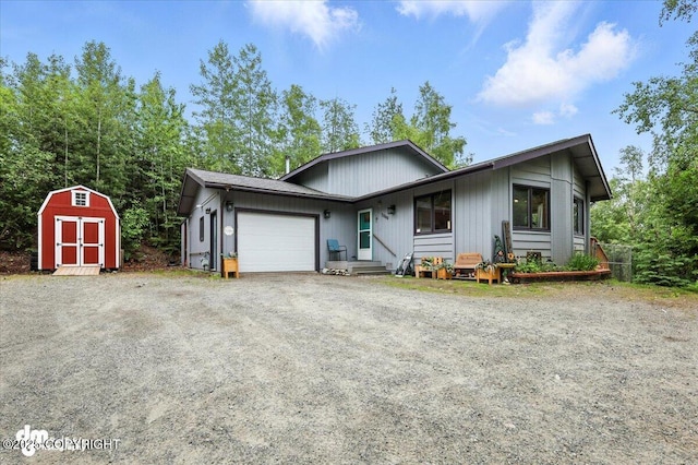 3800 E Birch View Dr, Wasilla, AK 99654 - view of front facade featuring an attached garage, a storage unit, and dirt driveway