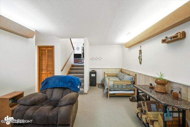 3800 E Birch View Dr, Wasilla, AK 99654 - living area with carpet, a textured ceiling, stairs, and wainscoting