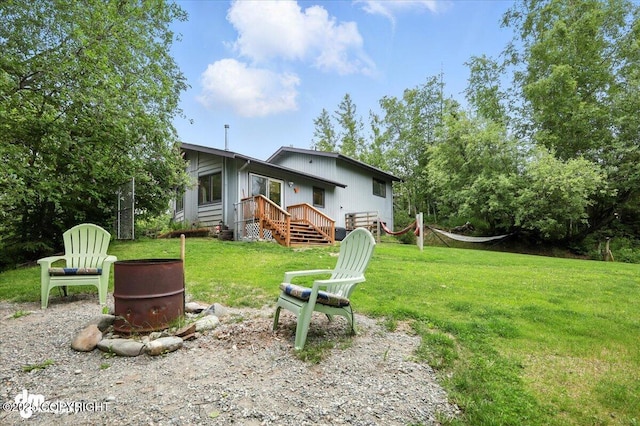 3800 E Birch View Dr, Wasilla, AK 99654 - back of house featuring a yard and an outdoor fire pit