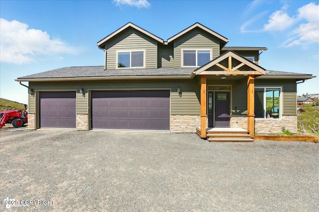 10380 Honey Bear Ln, Anchorage, AK 99516 - view of front of house with stone siding, driveway, and a garage