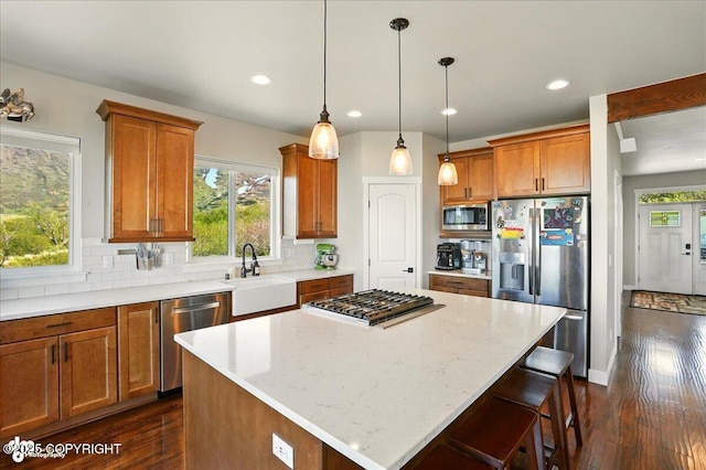10380 Honey Bear Ln, Anchorage, AK 99516 - kitchen featuring stainless steel appliances, dark wood-style floors, brown cabinets, and recessed lighting
