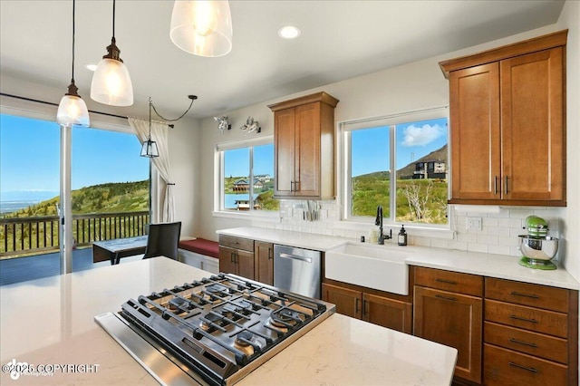10380 Honey Bear Ln, Anchorage, AK 99516 - kitchen featuring stainless steel dishwasher, cooktop, tasteful backsplash, brown cabinetry, and recessed lighting