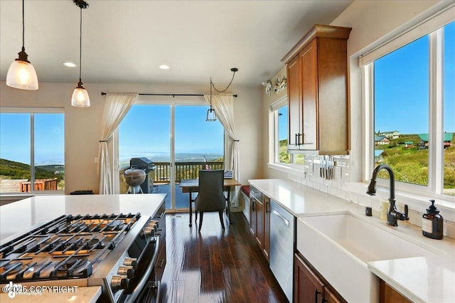 10380 Honey Bear Ln, Anchorage, AK 99516 - kitchen featuring stainless steel appliances, dark wood-style flooring, pendant lighting, light countertops, and recessed lighting
