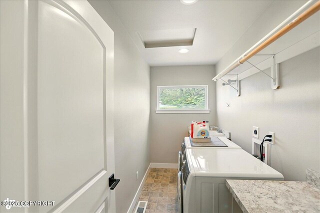 10380 Honey Bear Ln, Anchorage, AK 99516 - laundry area with stone finish floors, washing machine and clothes dryer, recessed lighting, and attic access