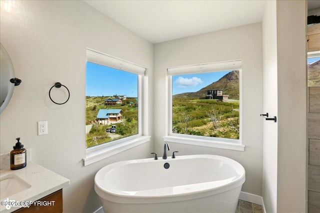 10380 Honey Bear Ln, Anchorage, AK 99516 - full bathroom featuring a soaking tub, vanity, and plenty of natural light