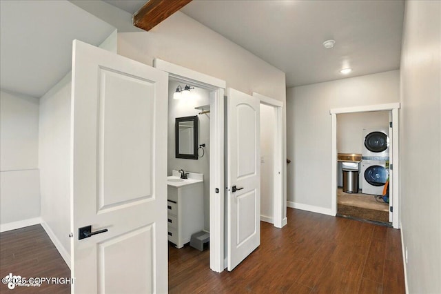 10380 Honey Bear Ln, Anchorage, AK 99516 - corridor featuring stacked washer / drying machine and dark wood-type flooring