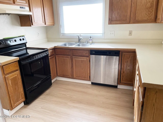 4310 Ambler Cir, Anchorage, AK 99504 - kitchen with stainless steel dishwasher, black / electric stove, under cabinet range hood, light wood-type flooring, and light countertops