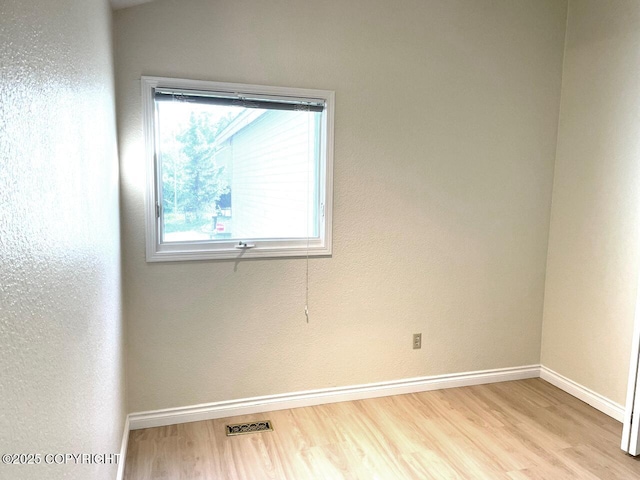 4310 Ambler Cir, Anchorage, AK 99504 - unfurnished room with wood finished floors and baseboards