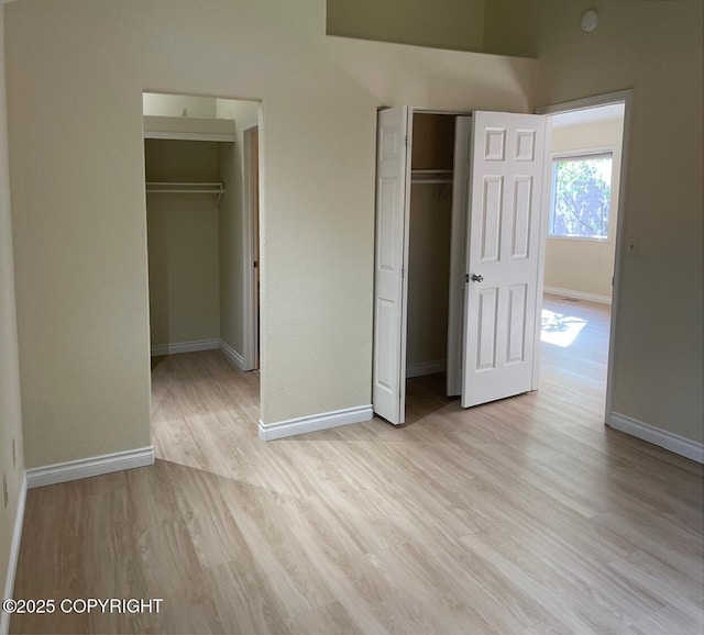 4310 Ambler Cir, Anchorage, AK 99504 - unfurnished bedroom with light wood finished floors and multiple closets
