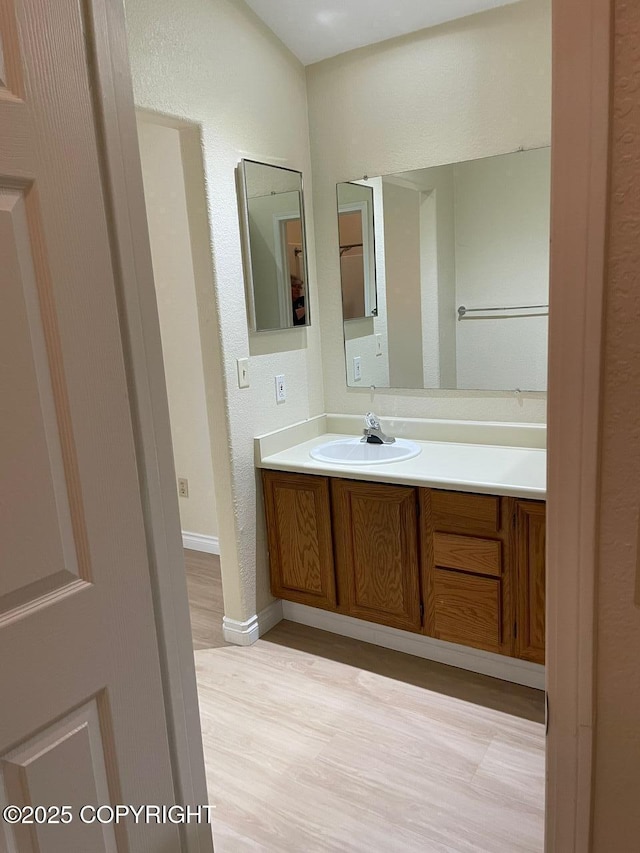 4310 Ambler Cir, Anchorage, AK 99504 - bathroom with wood finished floors, vanity, and a textured wall