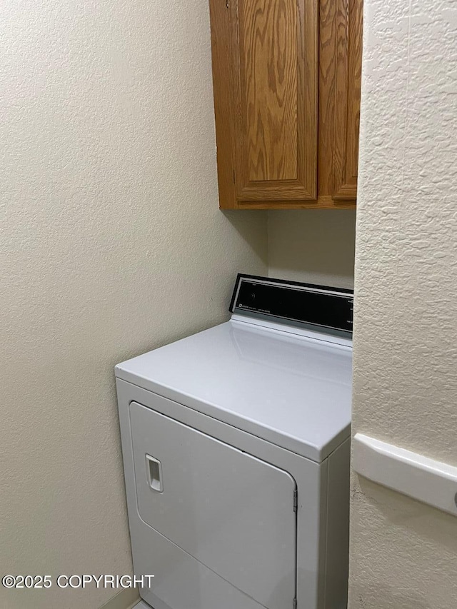 4310 Ambler Cir, Anchorage, AK 99504 - laundry room with washer / clothes dryer, cabinet space, and a textured wall