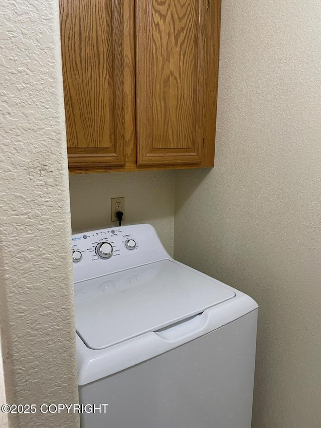4310 Ambler Cir, Anchorage, AK 99504 - washroom featuring washer / dryer and cabinet space