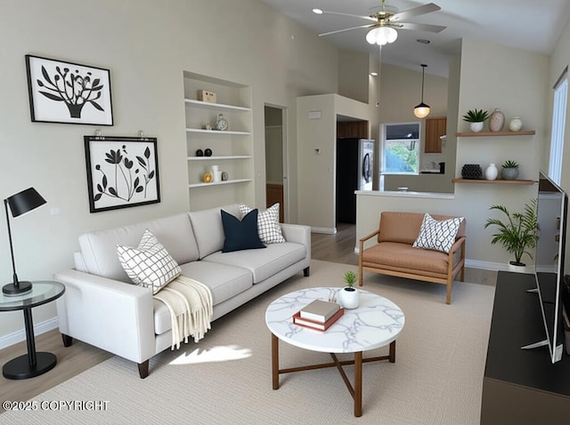 4310 Ambler Cir, Anchorage, AK 99504 - living area with wood finished floors, a ceiling fan, and high vaulted ceiling