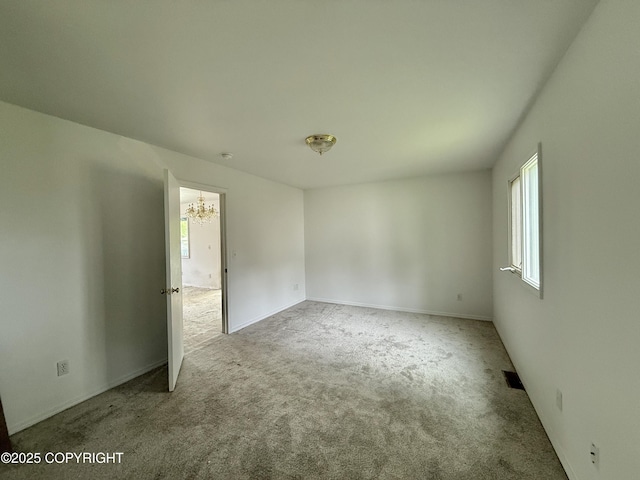 1140 Lalande Pl, Anchorage, AK 99504 - unfurnished room featuring plenty of natural light, carpet flooring, and a chandelier
