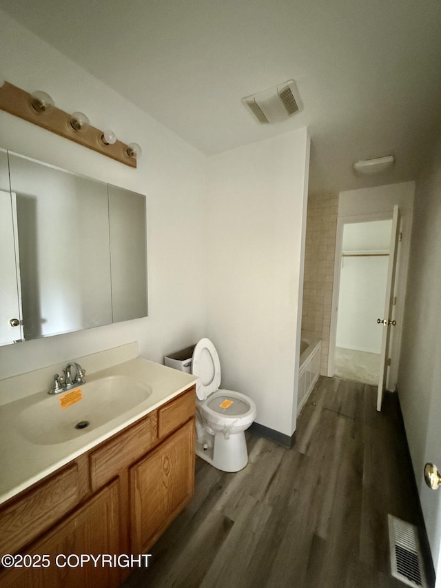 1140 Lalande Pl, Anchorage, AK 99504 - bathroom with wood finished floors, vanity, and bathing tub / shower combination