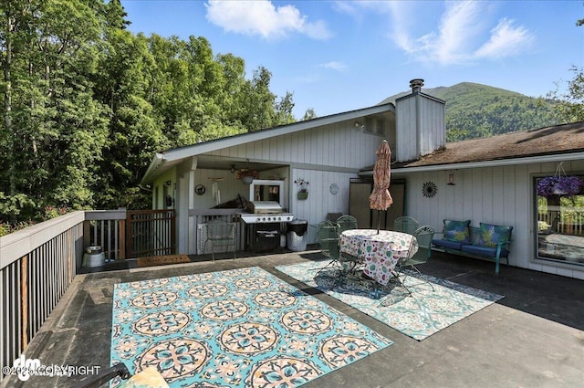 19360 Chugach Park Dr, Chugiak, AK 99567 - rear view of property featuring a patio area, a chimney, a ceiling fan, and a mountain view