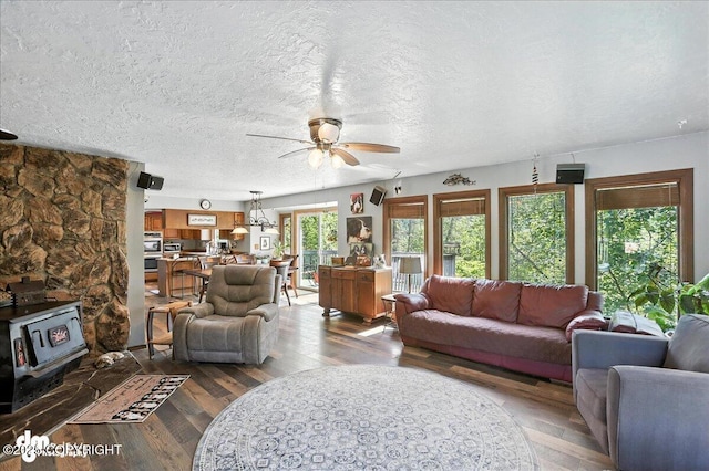 19360 Chugach Park Dr, Chugiak, AK 99567 - living area featuring a wood stove, a ceiling fan, hardwood / wood-style flooring, and a textured ceiling