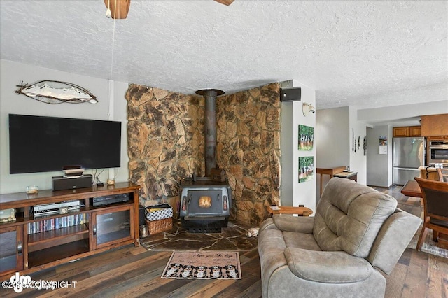 19360 Chugach Park Dr, Chugiak, AK 99567 - living area with a textured ceiling, a wood stove, and wood finished floors