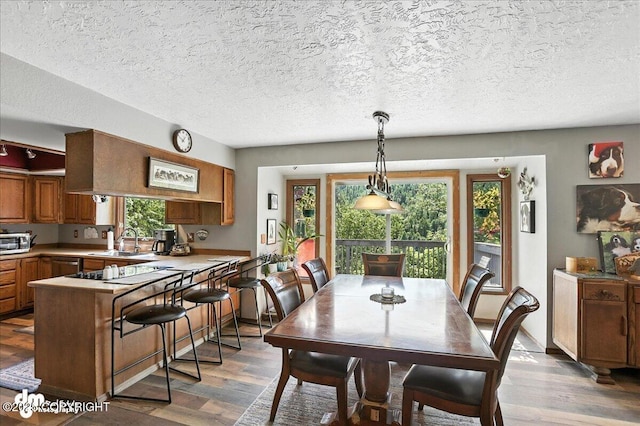 19360 Chugach Park Dr, Chugiak, AK 99567 - dining room featuring healthy amount of natural light, wood finished floors, and a textured ceiling