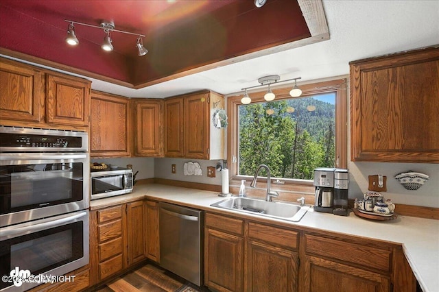 19360 Chugach Park Dr, Chugiak, AK 99567 - kitchen with stainless steel appliances, light countertops, brown cabinets, and dark wood finished floors