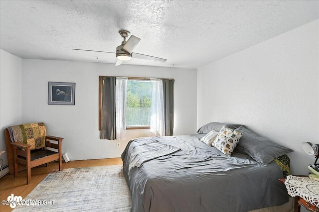 19360 Chugach Park Dr, Chugiak, AK 99567 - bedroom with wood finished floors, a textured ceiling, and ceiling fan