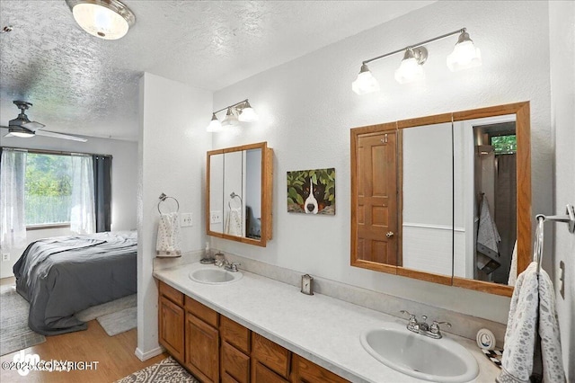 19360 Chugach Park Dr, Chugiak, AK 99567 - ensuite bathroom featuring double vanity, a textured ceiling, wood finished floors, and ceiling fan