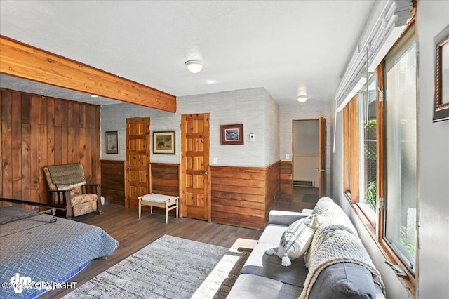 19360 Chugach Park Dr, Chugiak, AK 99567 - bedroom with wooden walls, wainscoting, wood finished floors, and beamed ceiling