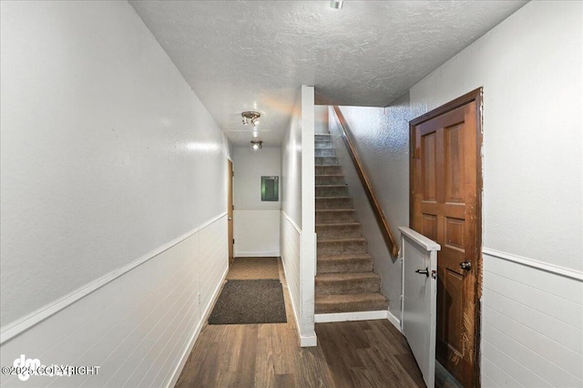 19360 Chugach Park Dr, Chugiak, AK 99567 - staircase with wood finished floors, wainscoting, a textured ceiling, and electric panel