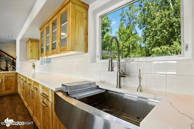 5100 W Lakeside Dr, Wasilla, AK 99654 - kitchen with tasteful backsplash, glass insert cabinets, light stone countertops, and dark wood finished floors